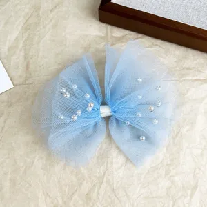 Blue tulle mesh pearl hair bow clip detail, elegant hair accessory for women and cute girls.