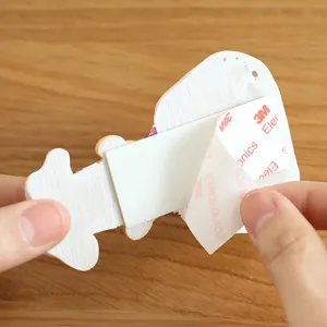 Cartoon plug holder cable organizer wall hook with strong adhesive backing for home kitchen.