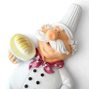 Cute cartoon chef wall hook and plug holder for kitchen decor and cable organization.