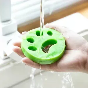 Reusable silicone pet hair remover for laundry, paw-shaped lint catcher for clothes and fur.