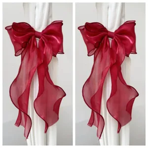 Red organza bow hair clip streaming ribbon DIY clothing accessory detail view showcase.