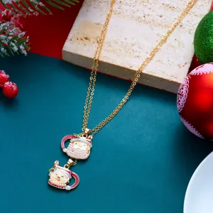 Primo piano delizioso della collana natalizia con ciondoli Babbo Natale in tazza
