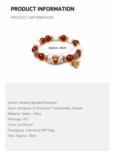 Detailed view of beaded bracelet featuring cow pendant and floral ceramic-style bead