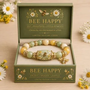 Detailed view of the bee and sunflower crystal bracelet in a premium green gift box