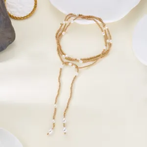 Close-up of gold beaded wrap necklace with delicate pearl tassels and elegant Y-shape design