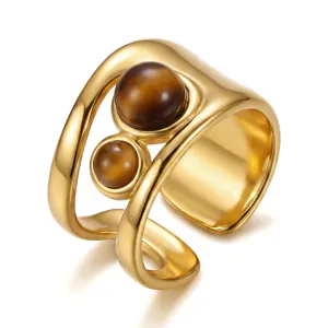 Close-up macro detail of a vintage gold-plated open ring featuring two brown tiger eye stones