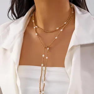 Elegant gold beaded Y-shaped long tassel necklace with white pearl accents on model