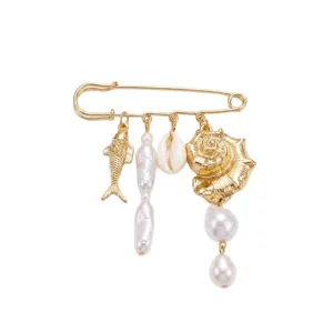 Gold safety pin brooch with ocean charms, fish, shell and baroque pearls.