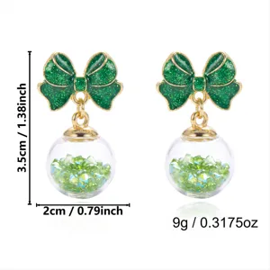 Detail view of green glitter bow crystal ball earrings with size and weight measurements.