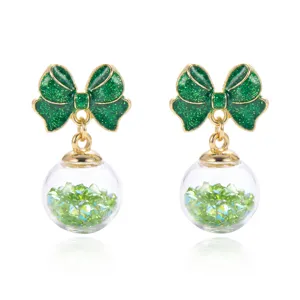 Elegant Christmas green bow earrings featuring glass balls filled with emerald crystals