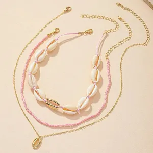Bohemian multi-layer shell necklace set with pink rice beads and gold chains for daily wear.