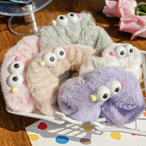 Soft plush hair scrunchies with cute big-eyed monster designs in various pastel colors
