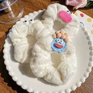 Ugly-cute monster plush scrunchies in cream white with quirky cartoon character details