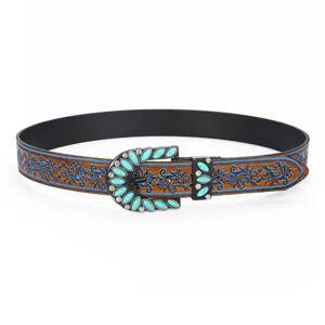 Detailed view of a vintage Western style belt for women with turquoise inlay and floral engraving