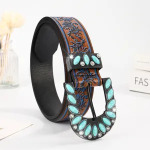 Close-up view of Western vintage belt featuring turquoise inlay and blue embossed pattern