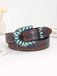 Close-up detail of vintage ethnic women's belt featuring turquoise buckle and floral patterns