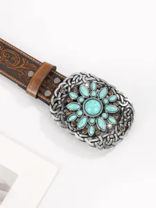 Dettaglio fibbia vintage western con fiore in turchese e cinturino in pelle scolpita