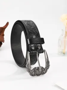 Vintage western style black leather belt with ornate floral embossing and silver buckle