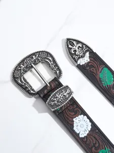 Detailed view of Bohemian floral engraved metal buckle and embossed leather belt pattern