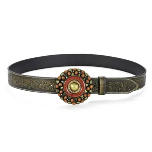 Detail shot of vintage Western cowboy embossed belt with ornate circular buckle
