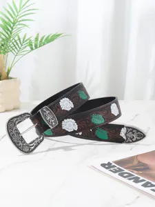 Detailed view of Bohemian style women's belt with floral patterns and ornate silver buckle