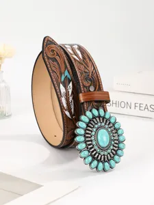 Close-up of vintage brown leather belt with turquoise stones and feather patterns.