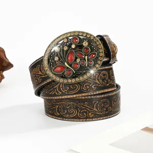 Detailed view of Western cowboy embossed leather belt with ornate rhinestone buckle