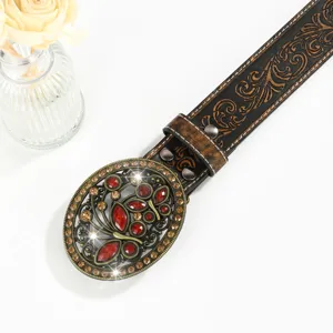 Close-up of vintage western belt with embossed leather and ornate rhinestone buckle