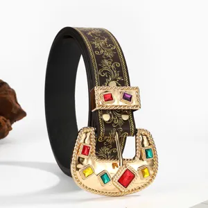 Close-up of Western cowboy belt buckle with colorful gemstones and gold embossed patterns