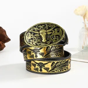 Detail of retro western cowboy belt with golden bull head buckle and embossed pattern