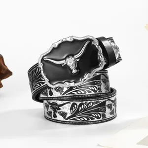 Close-up of Western cowboy belt featuring embossed floral patterns and a silver bull head buckle