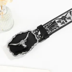 Detailed close-up of a Western cowboy belt with an embossed bull head buckle and retro pattern