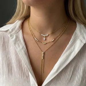 Detailed view of layered stainless steel necklaces with sparkling zirconia stones