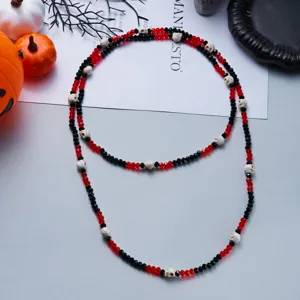 Halloween necklace featuring red and black faceted beads and detailed skull accents.