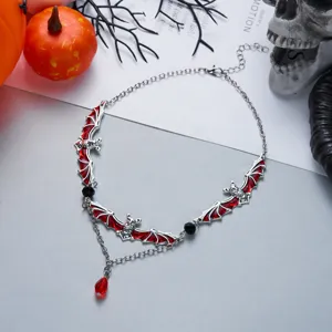 Gothic Halloween bat necklace featuring red enamel wings and teardrop crystal pendant detail