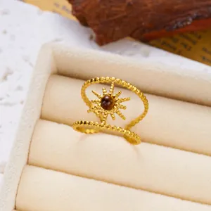 Detail of a vintage gold double-layer sunburst ring with a tiger eye stone.
