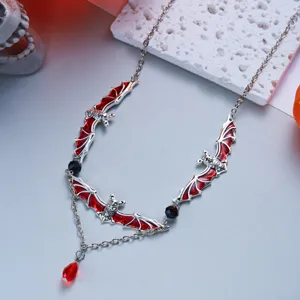 Detailed view of Gothic Halloween bat necklace with red enamel and silver chain