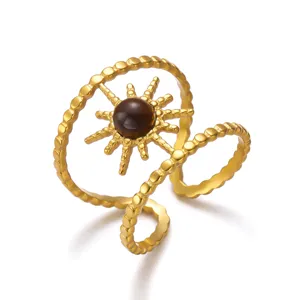 Detailed view of retro stainless steel sun ring with brown tiger's eye stone