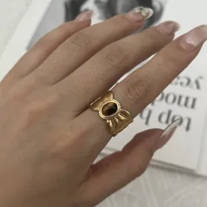 Close-up of retro stainless steel ring with tiger eye stone and carved leaf design