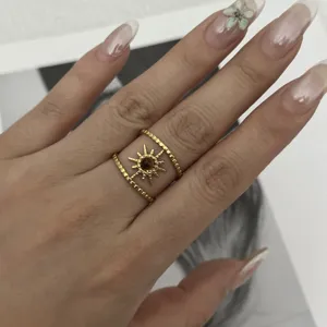 Close-up of vintage gold double-layer sun ring with tiger eye stone center on finger