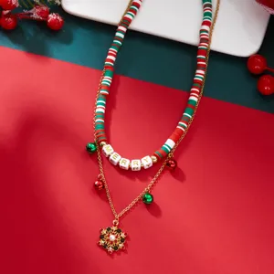 Detail of festive Christmas double-layer necklace with clay beads and bell charms.
