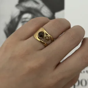 Elegant vintage stainless steel ring with tiger's eye stones on a model's finger