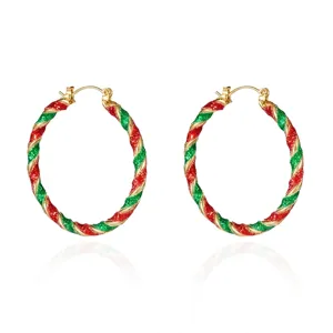 Close-up detail of festive red and green glitter twisted Christmas hoop earrings for women