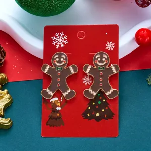 Dettaglio macro di orecchini di Natale omino di pan di zenzero su carta
