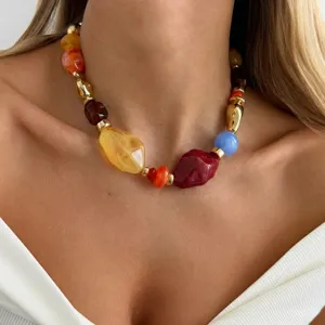 Close-up detail of a women's necklace featuring colorful irregular marbled resin beads.