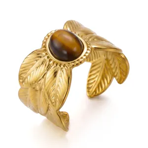 Detail shot of a vintage gold-plated stainless steel feather ring with tiger's eye stone