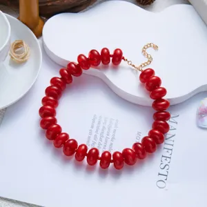 Detailed view of fashionable bohemian red resin bead necklace featuring a gold adjustable chain