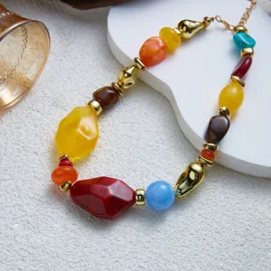 Detailed close-up showing the texture of colorful irregular resin beads and gold accents