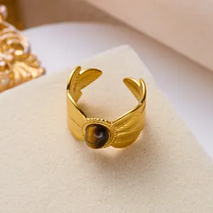 Detail view of a vintage stainless steel ring with tiger eye stone and wing design