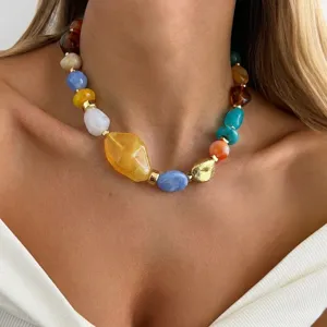 Detailed view of a vibrant chunky resin beaded necklace on model's neckline